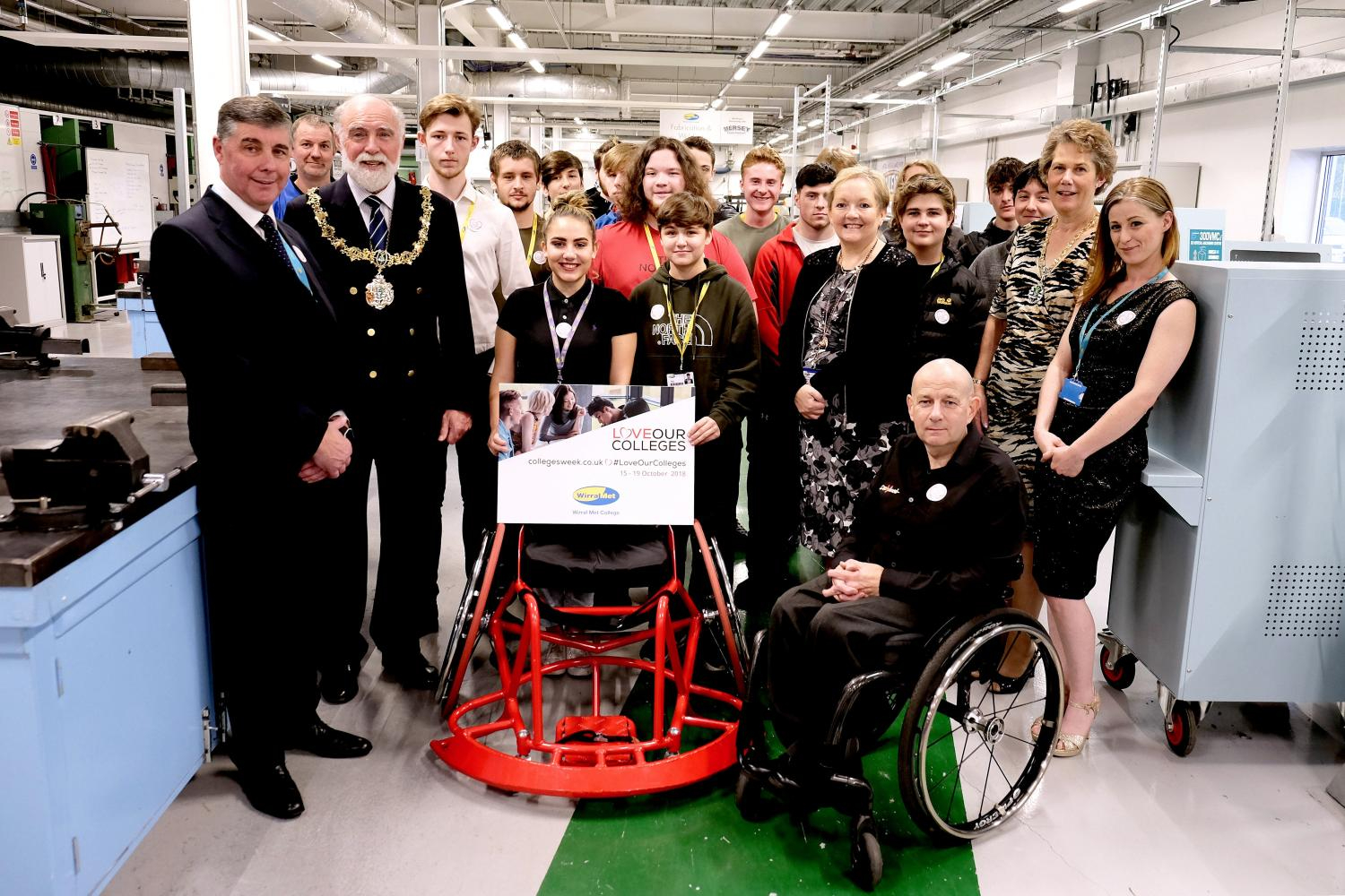 Mayor and Mayoress standing next to Wirral Met Stem Students in Twelve Quays Stem Engineering Room