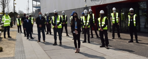 Students and staff stood outside Wirral Waters campus in high vis 