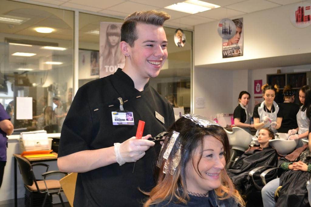 Wirral Met Hairdressing student Ashley Waterhouse styling a female client's hair