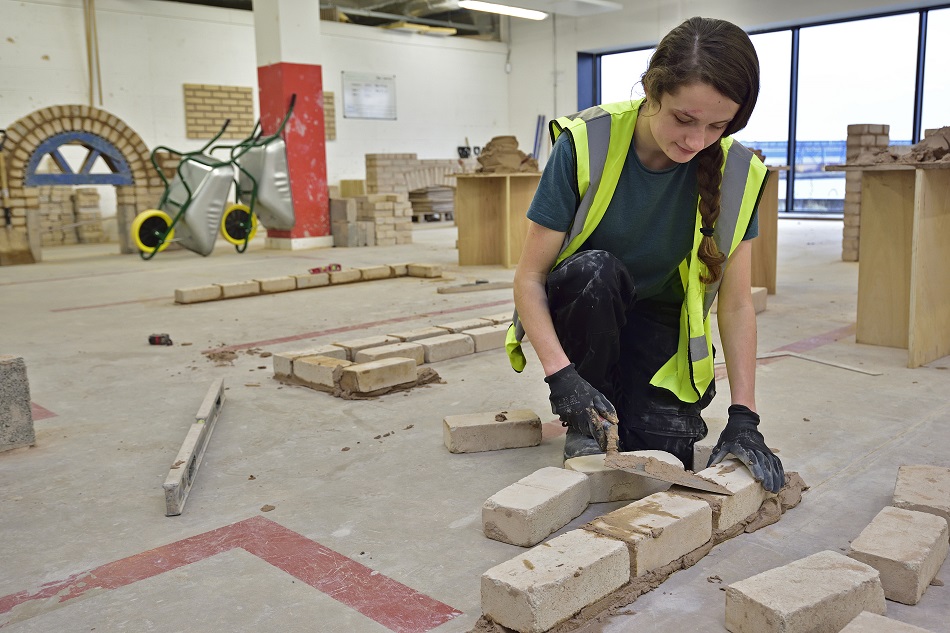 Female Wirral Met Bricklaying Student  working in a classroom at Wirral Waters Campus