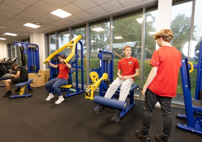 Five Sports Fitness And Outdoor Education Students Playing Football On Astroturf