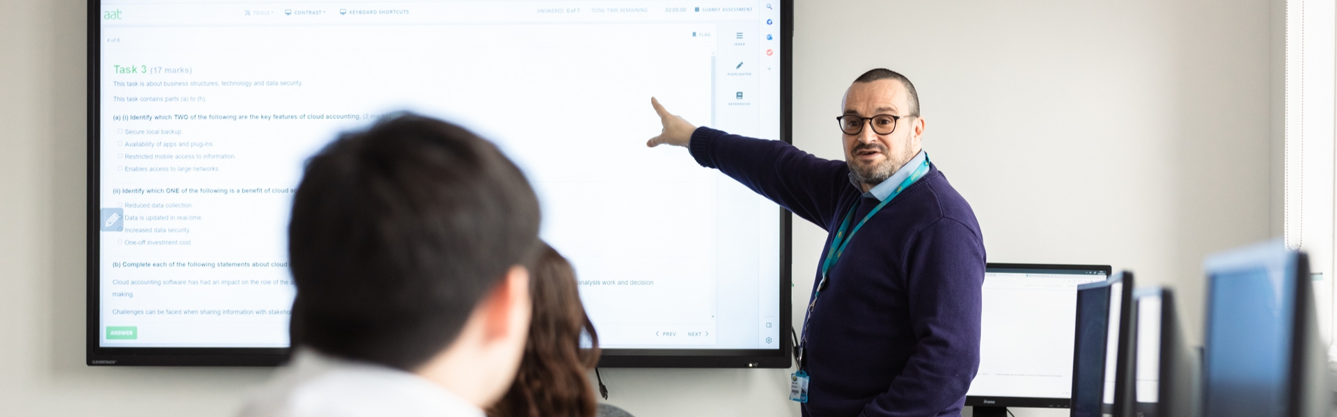 Business tutor teaching a class of students at the Hamilton campus.