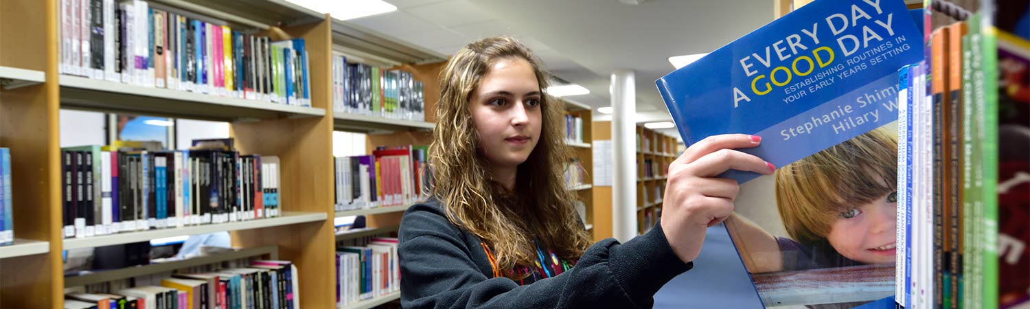 girl taking book