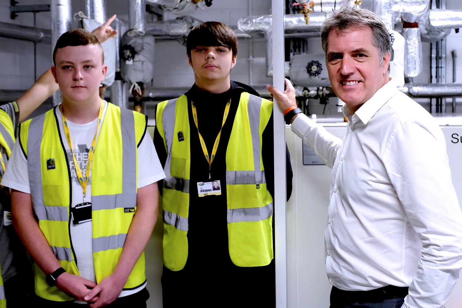 Metro Mayor Steve Rotheram standing with Wirral Met Students wearing Hi-Vis