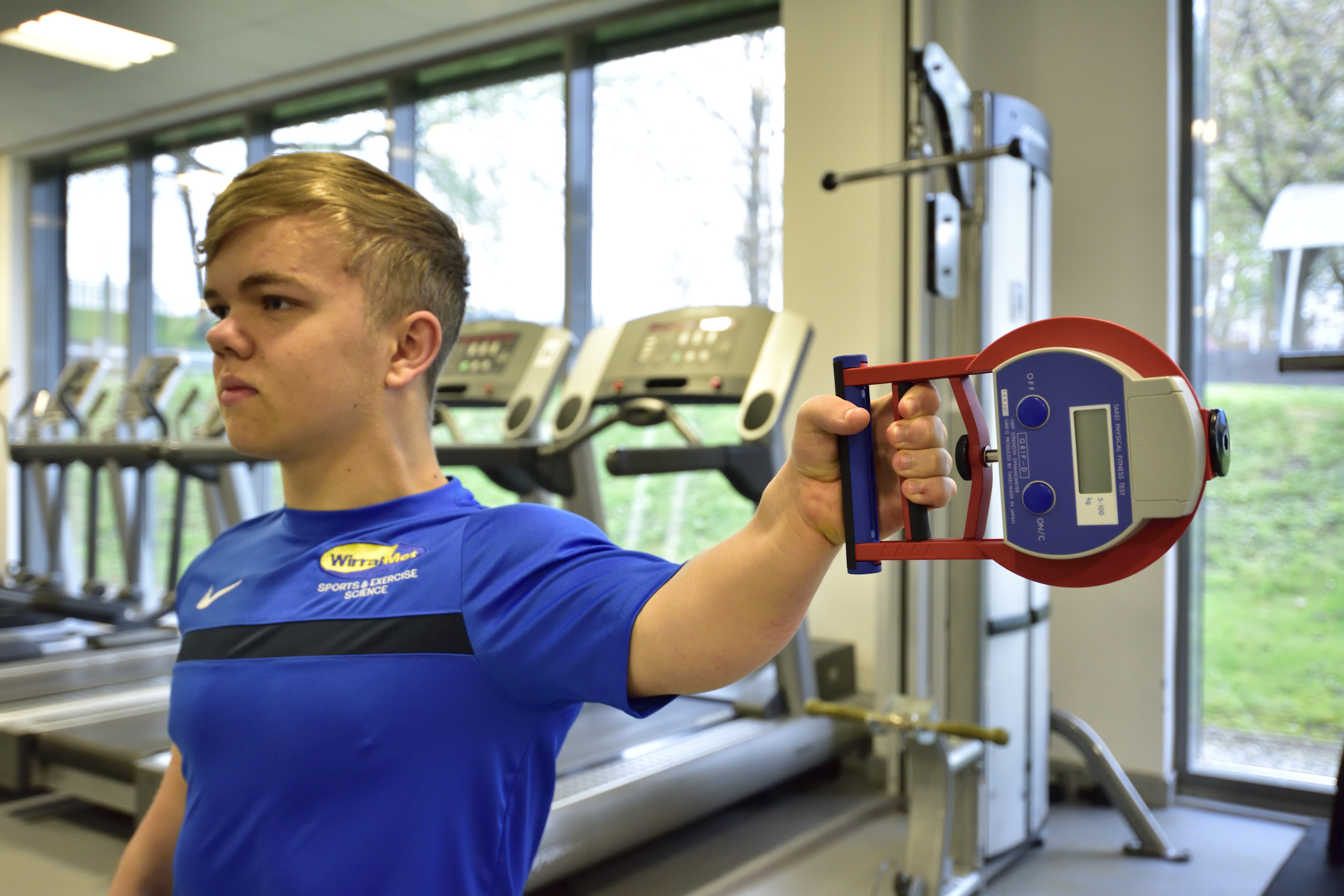 Wirral Met Sport Student exercising wearing Wirral Met branded blue t-shirt